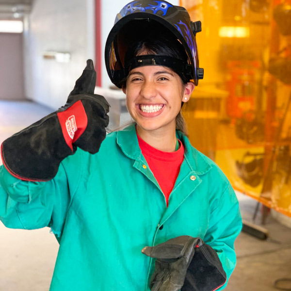 Student in welding gear at Women in Construction Management Summer Institute.