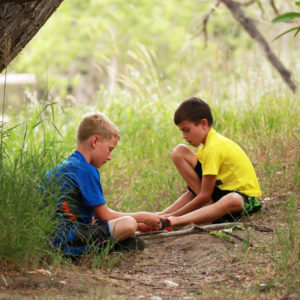 Two boys with sticks at CSU's Environmental Learning Center (ELC)