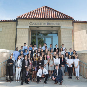 Graduates of CSU's summer Global Business Academy gather on the steps of the College of Business