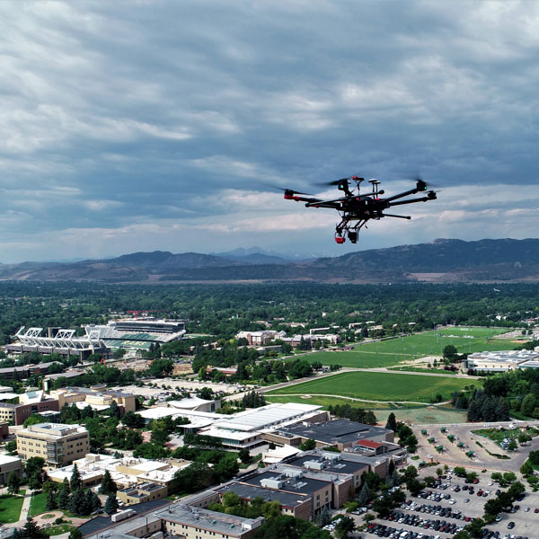Drone flies over the CSU campus with Long's Peak in the background.