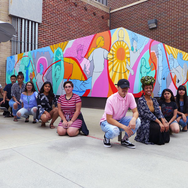 CSU summer students in Social Justice thru the Arts at Colorado State University gather in front of their mural made with artist Rose Jaffe.