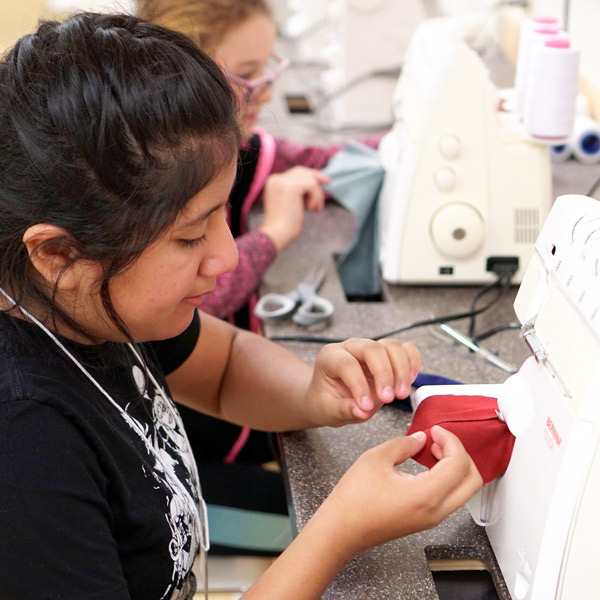 Student using sewing machines at CSU Fashion Fundamentals summer program.